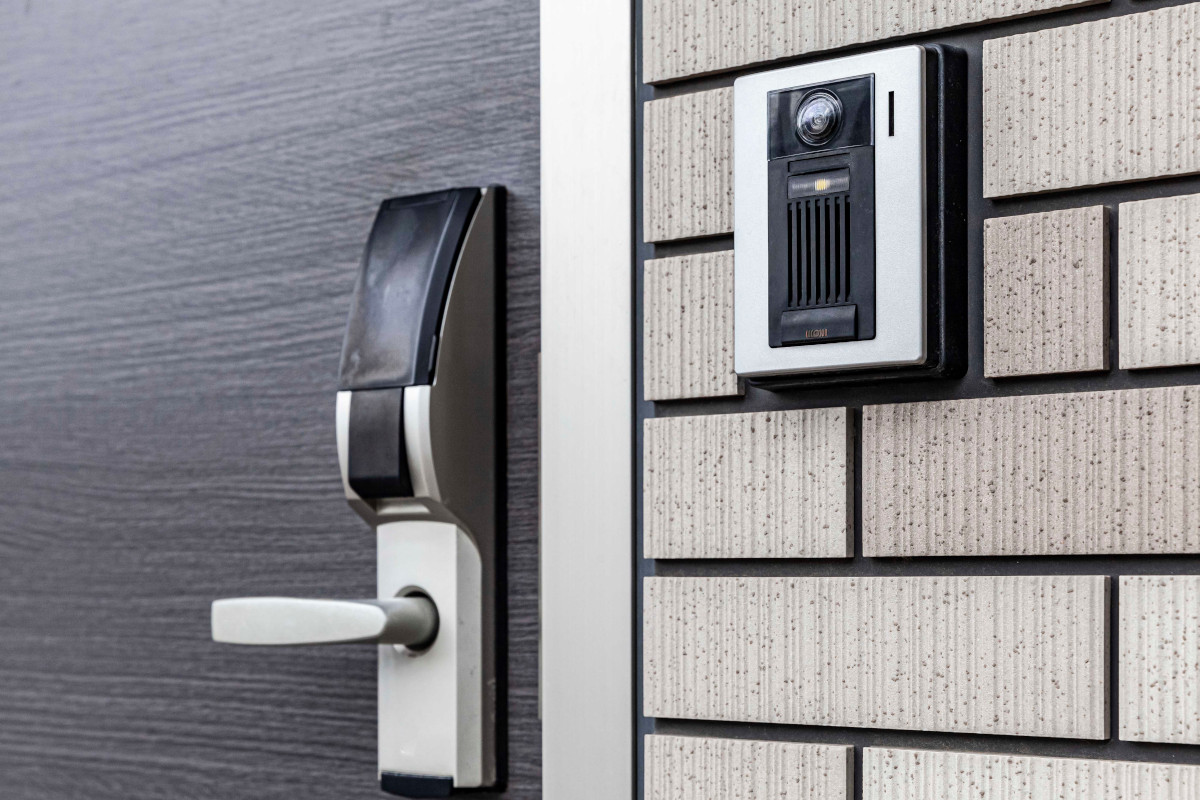 A biometric pad on an exterior wall next to a locked door