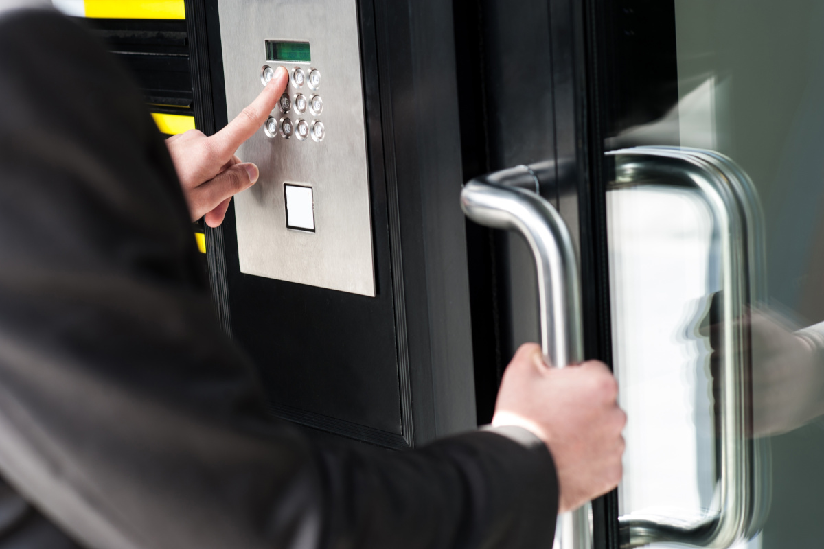 A person attempting to gain access to an area with an access control security door