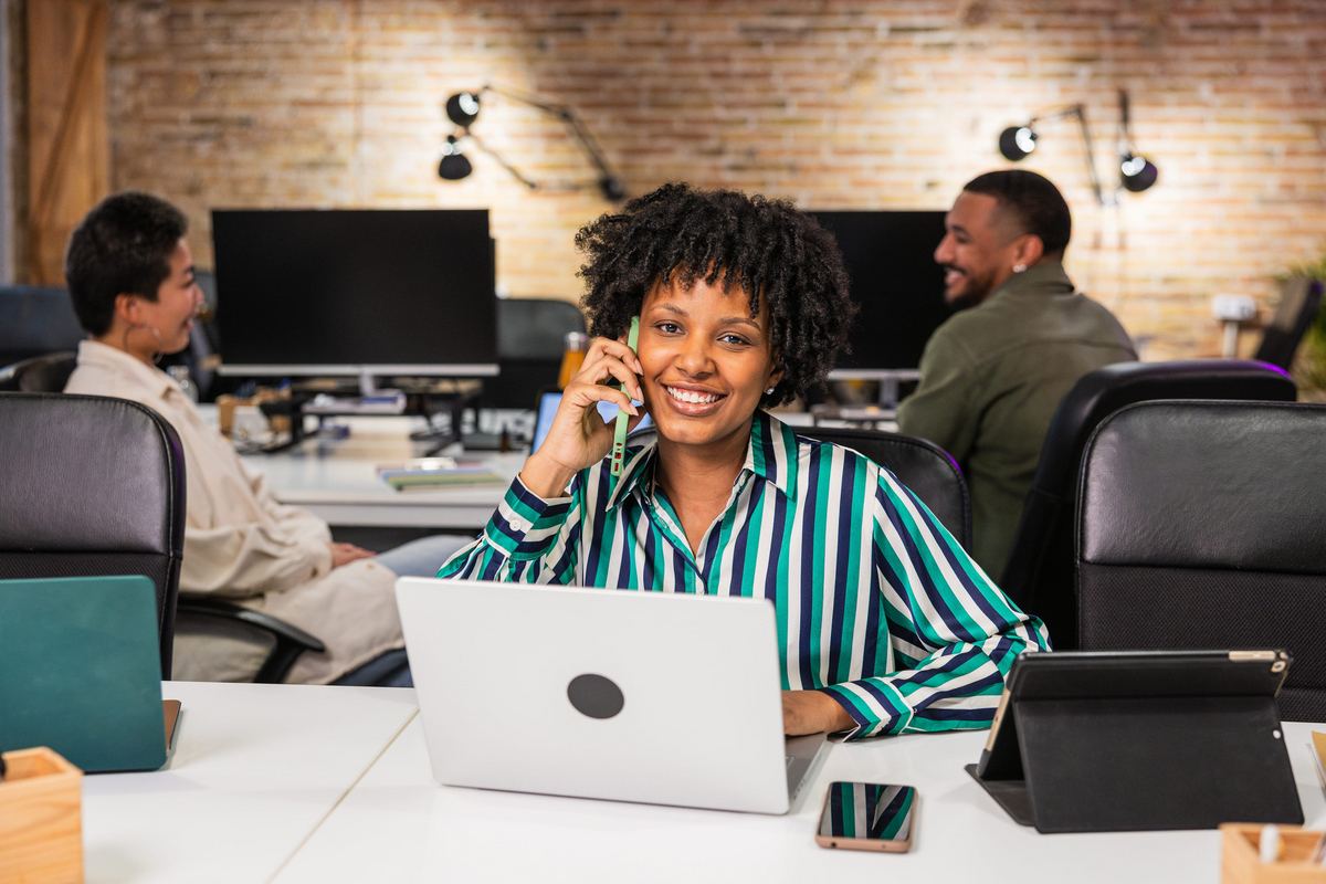 Employee talking on a desk phone in an office