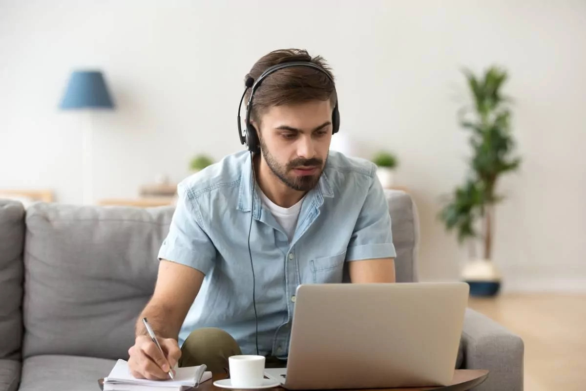 Man with headphones working on laptop