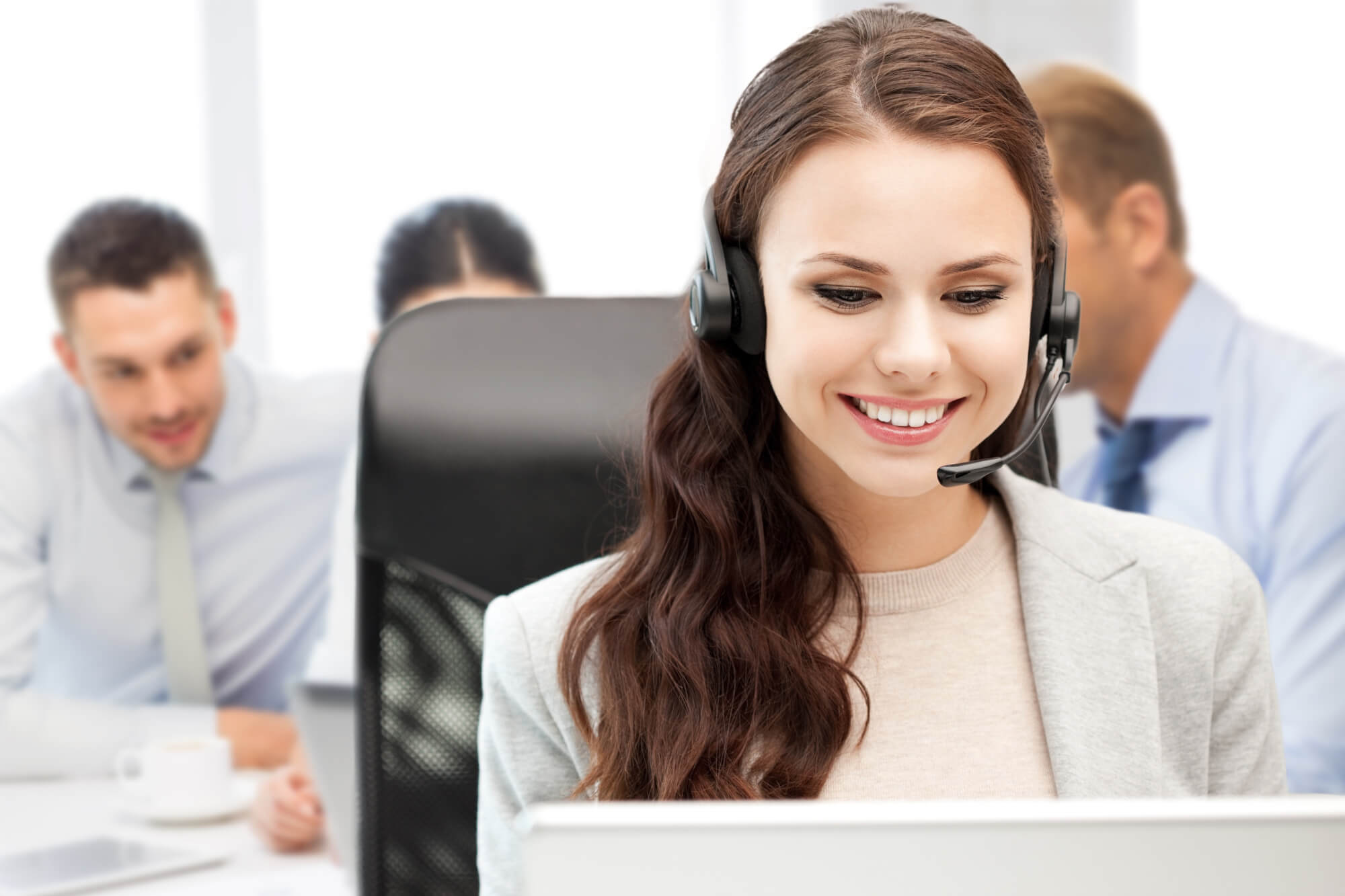 Woman in call center wearing VoIP headset